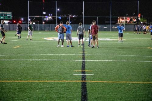 A photo of students playing and spectating on the turf field